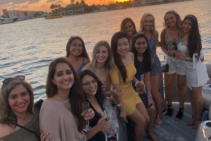 Prajakta Shukre et al. posing in front of a body of water