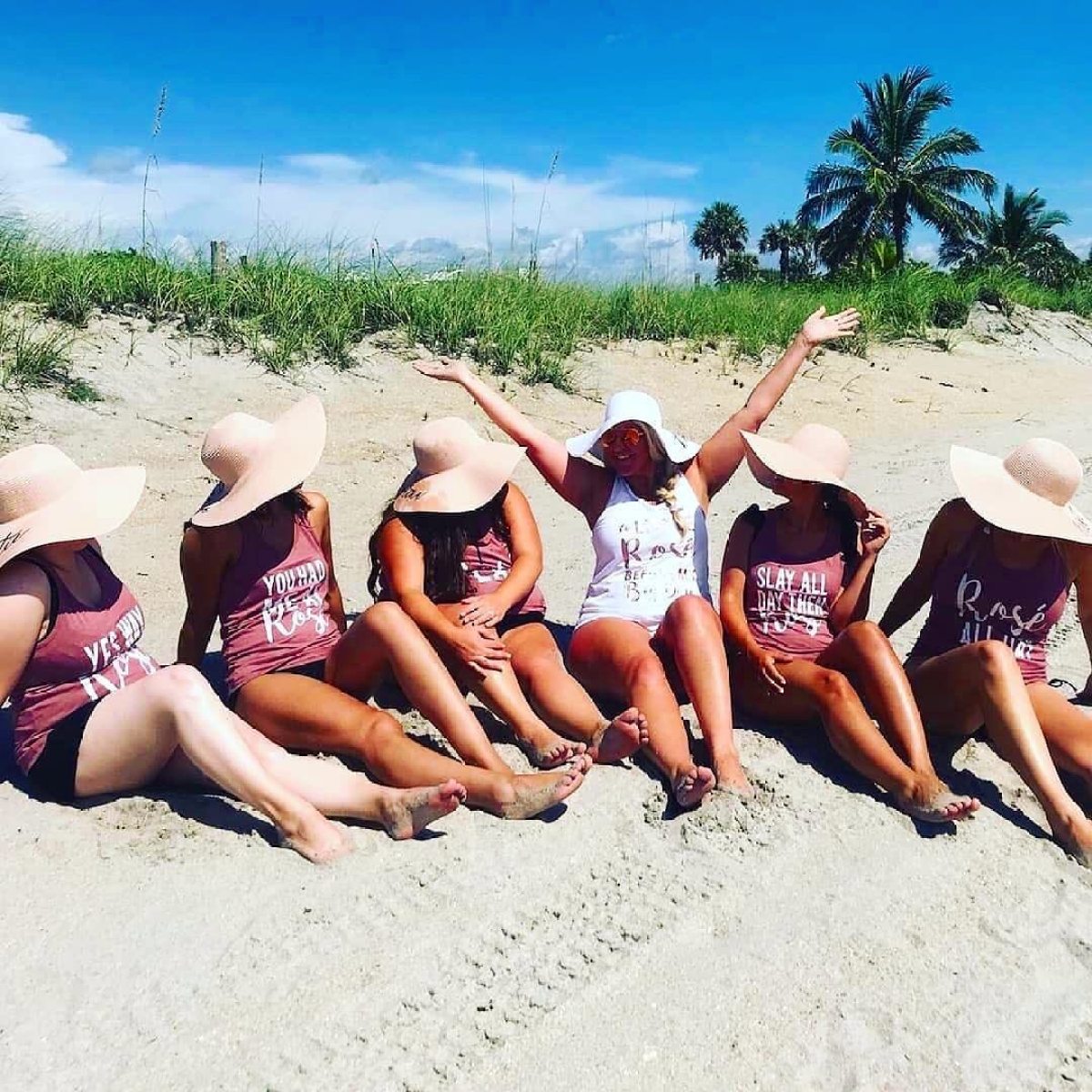 a group of people on a beach posing for the camera