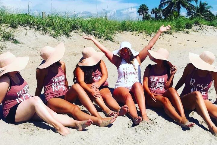 a group of people on a beach posing for the camera