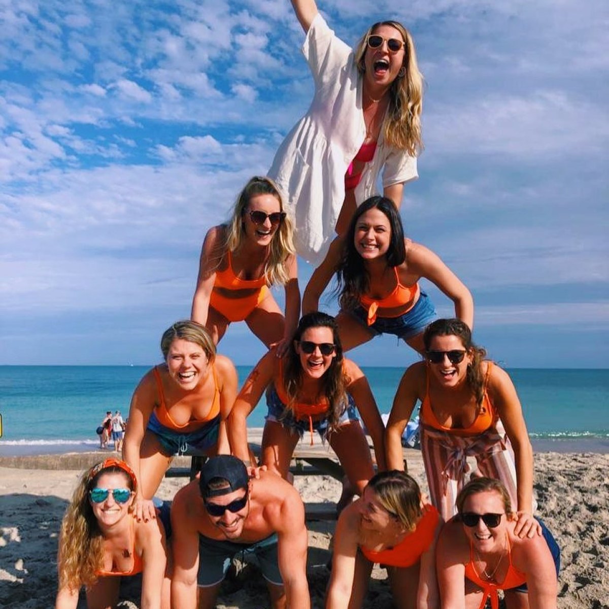 a group of people on a beach posing for the camera