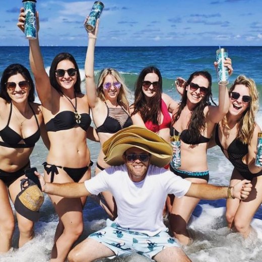 a group of people on a beach posing for the camera