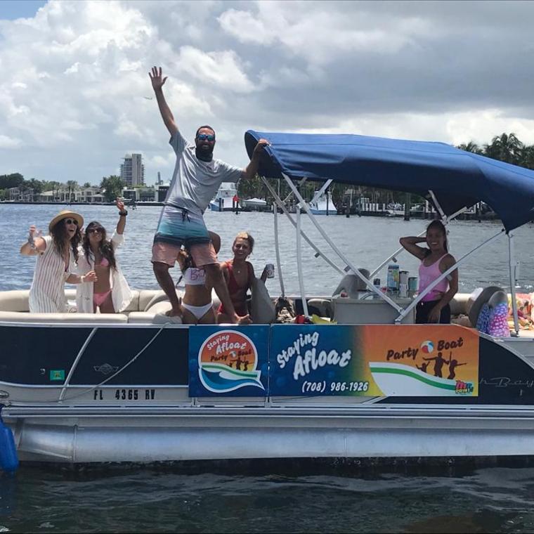 a group of people on a party boat in the water