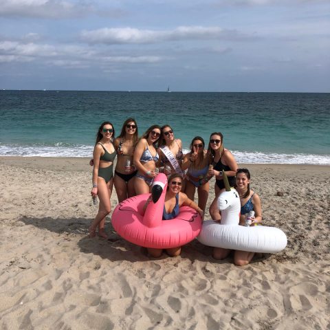 a group of people sitting at a beach