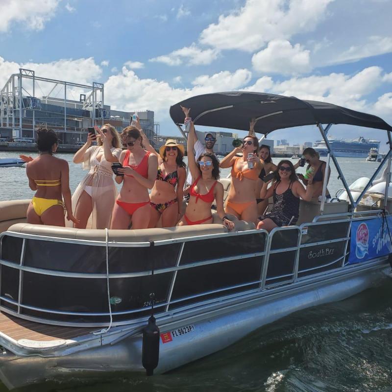 a group of people in a boat docked next to a body of water