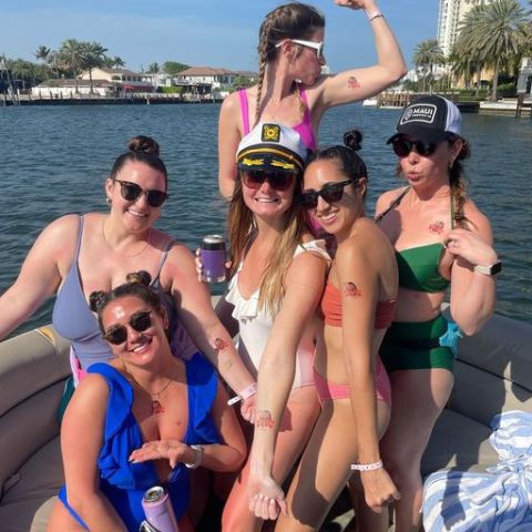 a group of people on a beach posing for the camera